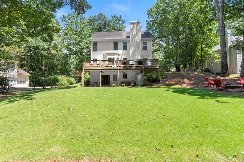 313 Thorntree Lane Canton, GA 30115 - Photo 50 of 51 a white house with a big yard and large trees