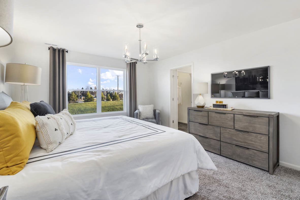 Undisclosed Address Elgin, IL 60124 - Photo 17 of 19 a bedroom with a bed and a flat tv screen on dresser