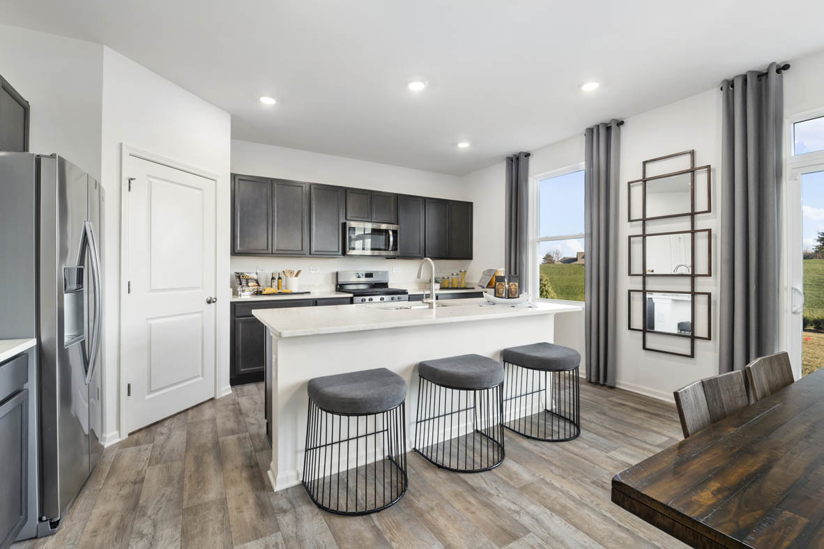 Undisclosed Address Elgin, IL 60124 - Photo 4 of 19 a kitchen with stainless steel appliances granite countertop a refrigerator a stove a sink and a dining table with wooden floor