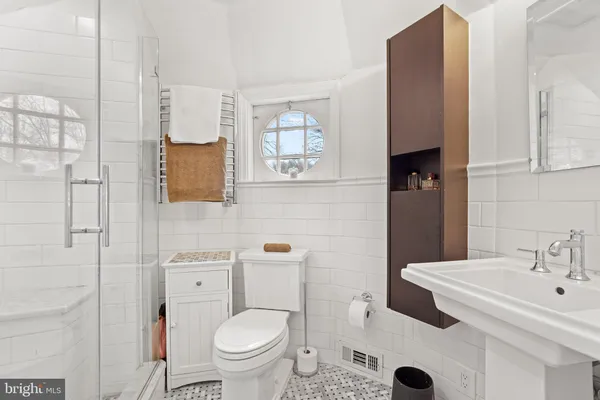 a bathroom with a sink toilet and mirror