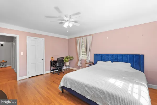 a spacious bedroom with a bed and a chandelier