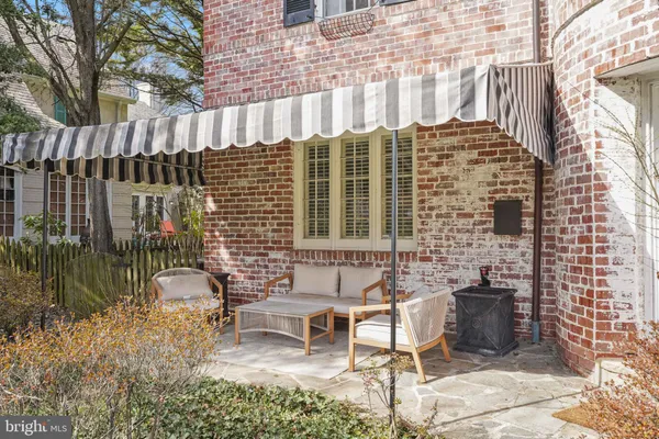 a view of a patio with a table and chairs and potted plants