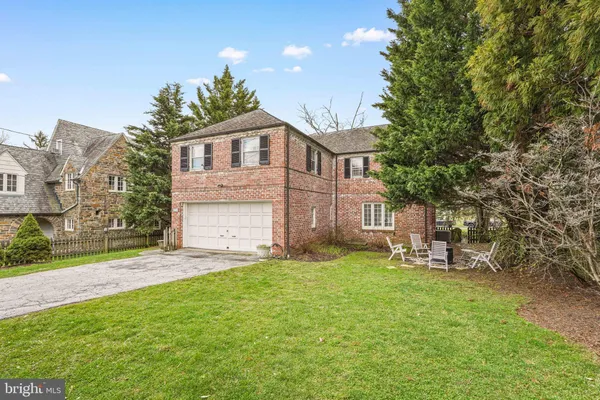 a front view of a house with a garden and yard