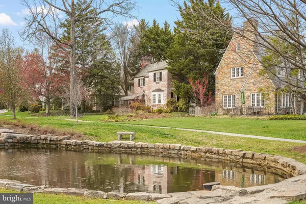 a view of a house with a yard and a trees