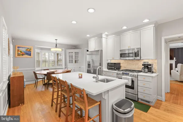 a kitchen with a table chairs stove and cabinets
