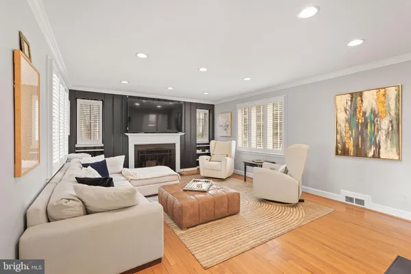 a living room with furniture fireplace and window