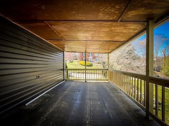 a view of a room with wooden floor