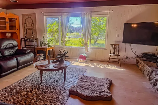 a view of a workspace with furniture window and wooden floor