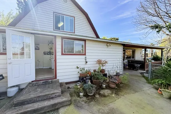 a bathroom with a toilet sink a mirror a vanity and window