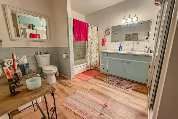 a bathroom with a toilet sink and a mirror