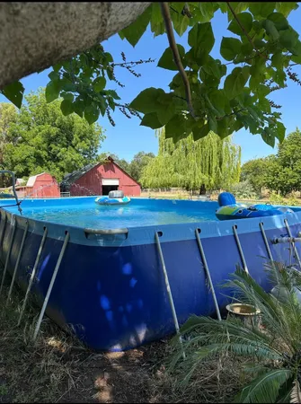 a view of yard with swimming pool and outdoor seating