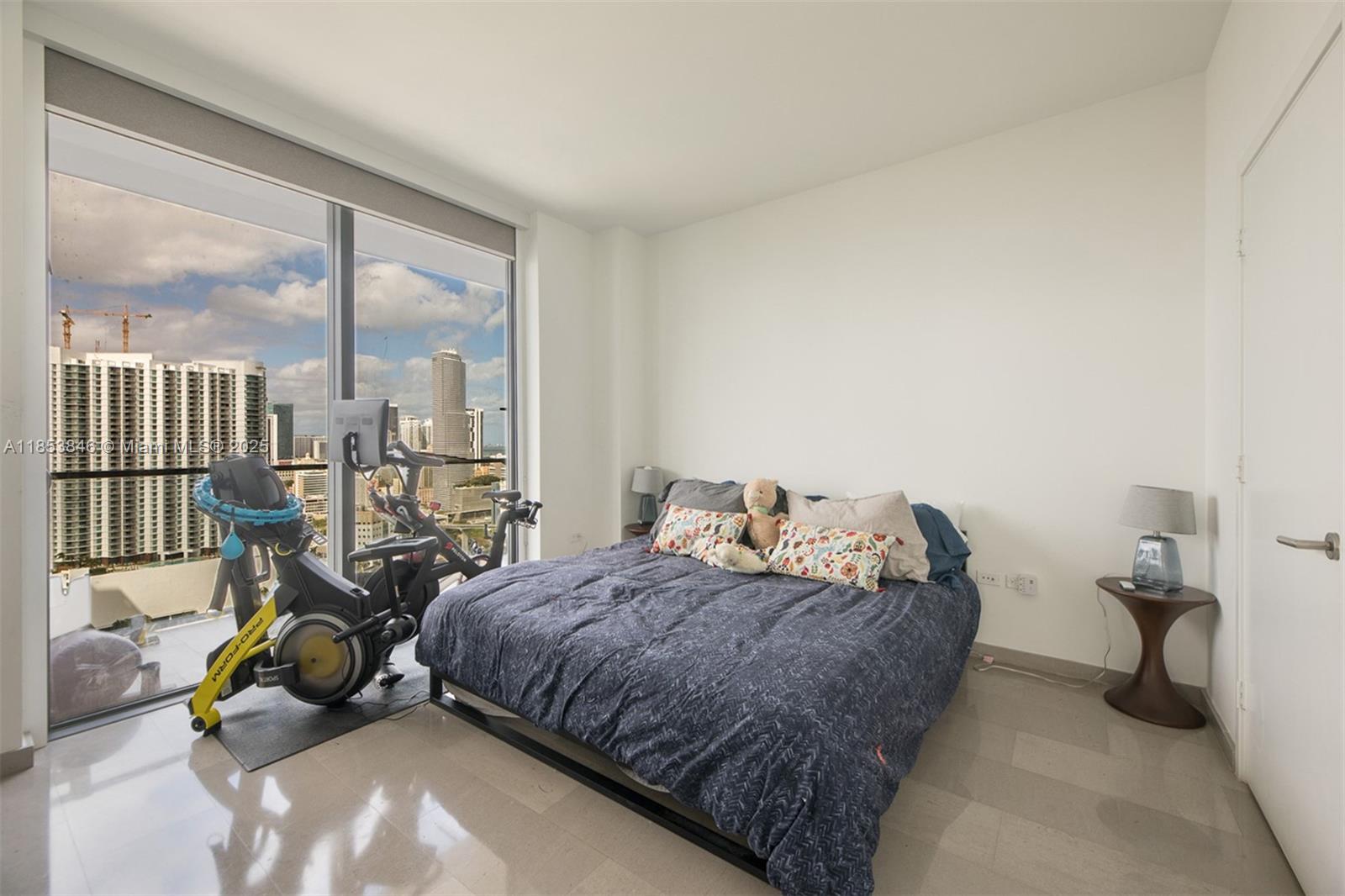 88 Southwest 7th Street, Unit 2312 Miami, FL 33130 - Photo 13 of 34 a bedroom with bed and glass door