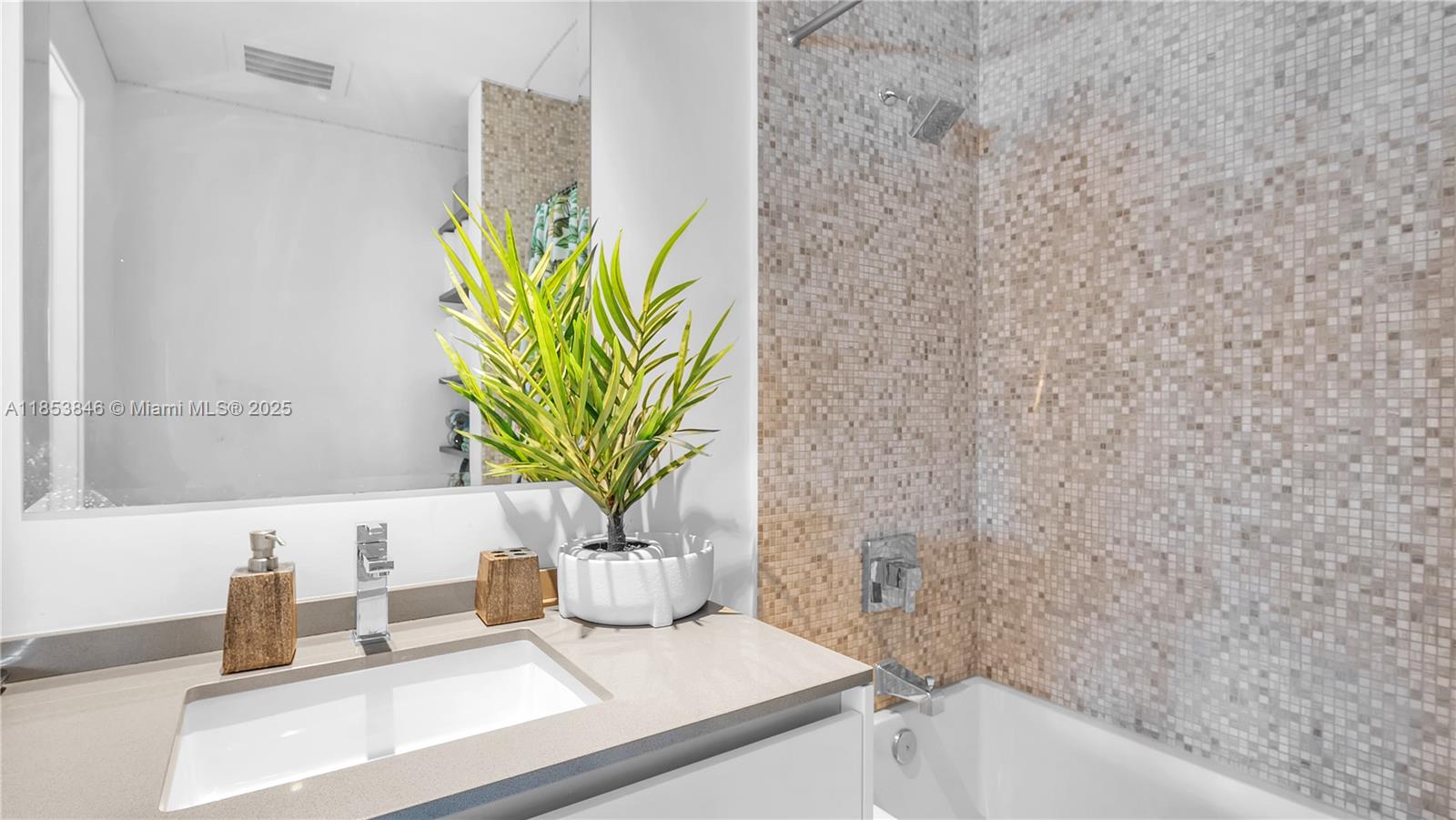 88 Southwest 7th Street, Unit 2312 Miami, FL 33130 - Photo 14 of 34 a bathroom with a granite countertop sink a toilet and a bathtub