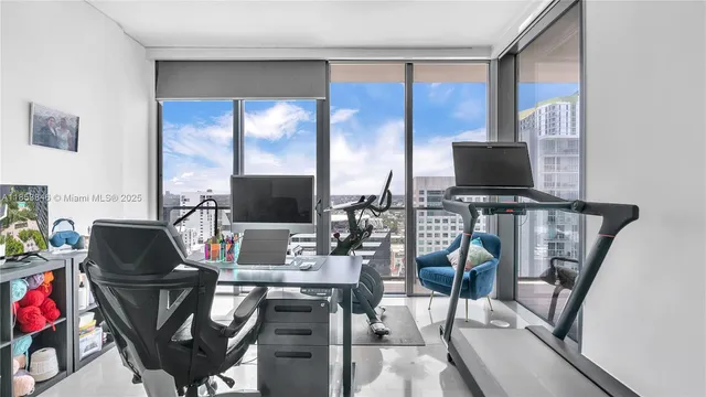 a view of a hallway with a dining table & chairs