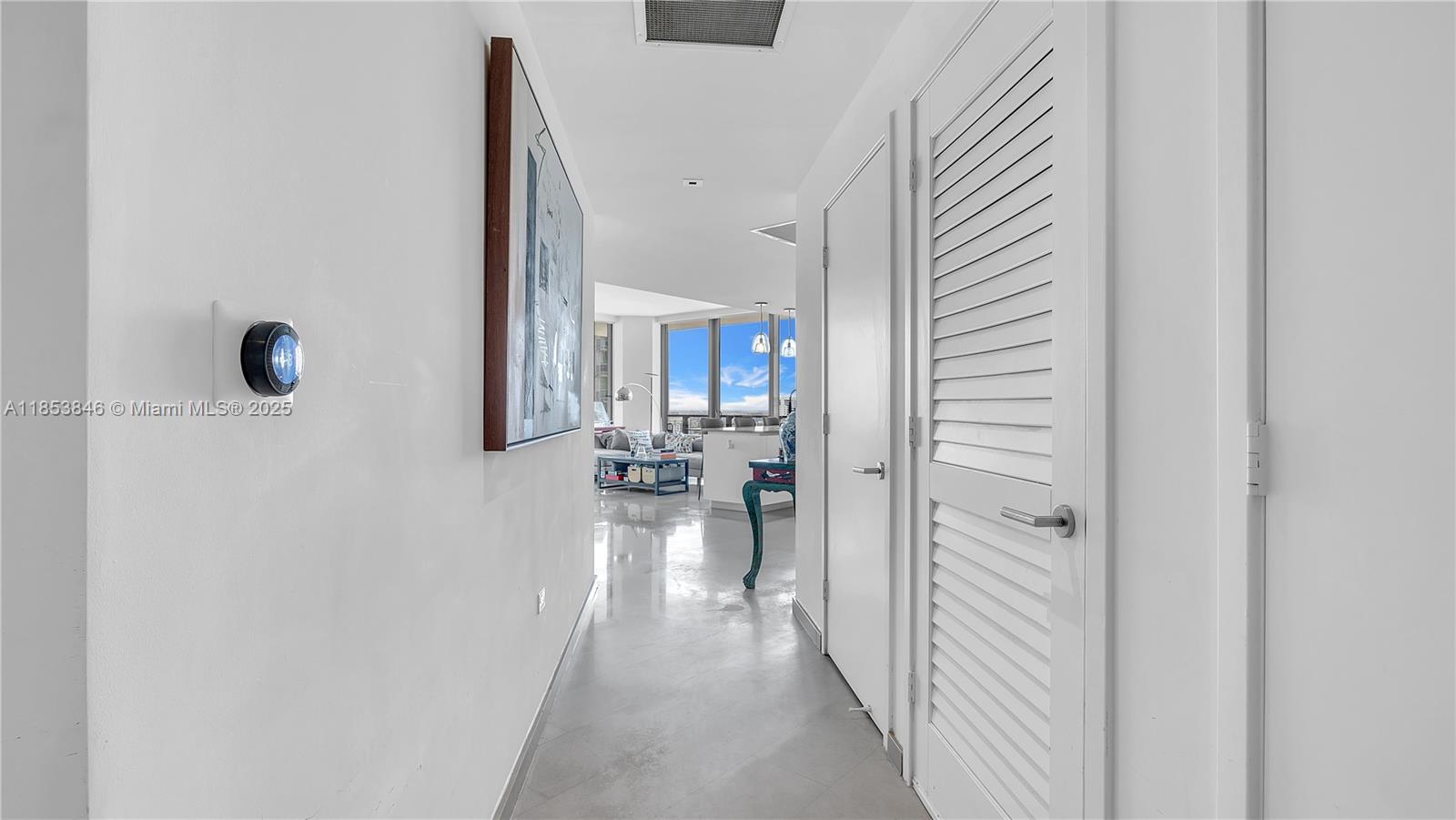 88 Southwest 7th Street, Unit 2312 Miami, FL 33130 - Photo 19 of 34 a view of a hallway with a dining table & chairs