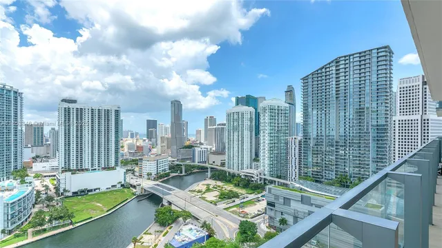 a large white kitchen with a large window
