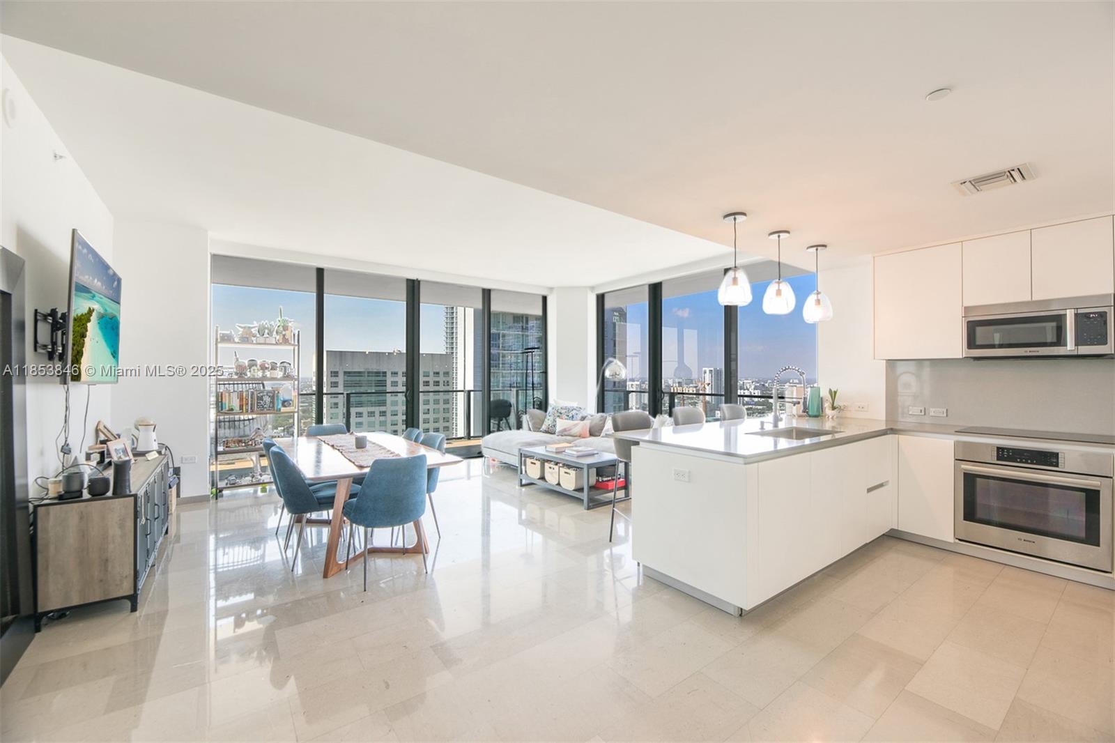 88 Southwest 7th Street, Unit 2312 Miami, FL 33130 - Photo 4 of 34 a large white kitchen with a large window