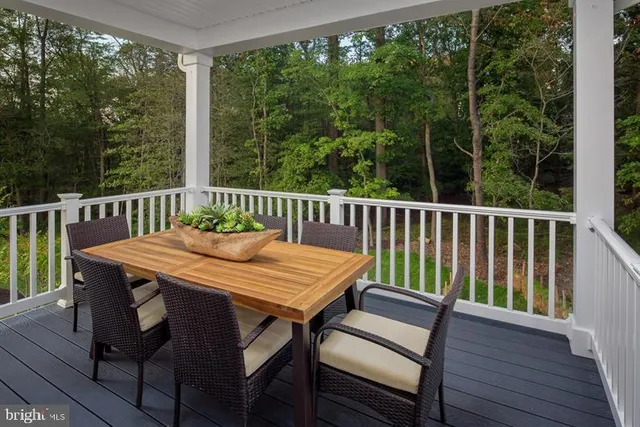 a view of a dining table and chairs on the roof deck