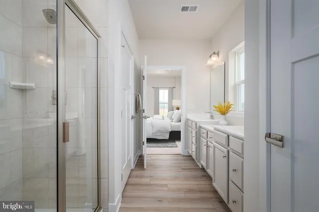 a bathroom with a double vanity sink and mirror