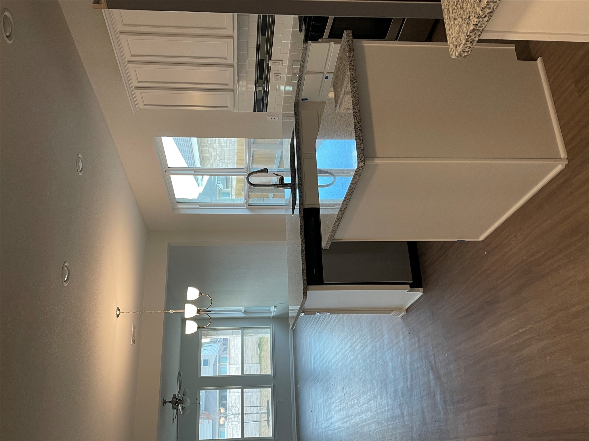 3908 Birdwatch Loop, Unit 56 Pflugerville, TX 78660 - Photo 4 of 30 a kitchen with stainless steel appliances granite countertop a sink a stove and a wooden floors