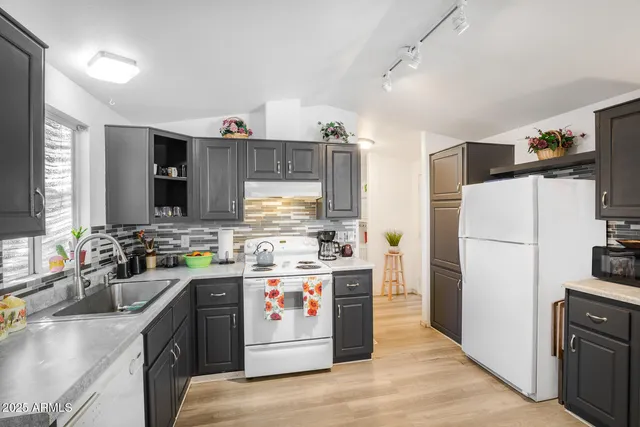 a kitchen with a stove a refrigerator and a sink