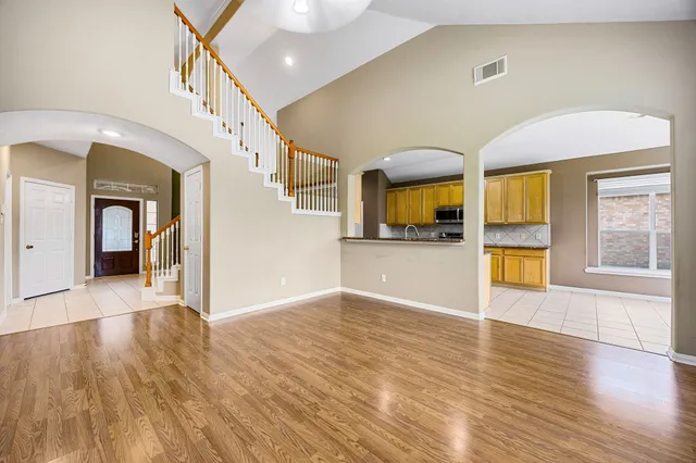 a large kitchen with stainless steel appliances granite countertop a sink and cabinets