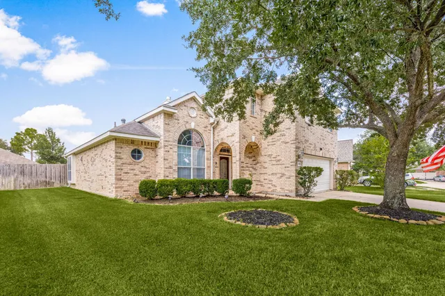 a view of a livingroom with wooden floor and stairs