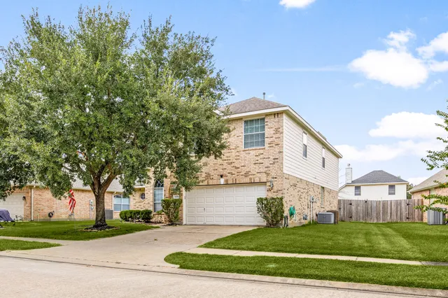 a view of a big room with wooden floor a fireplace and windows