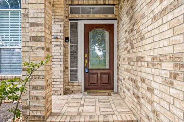a view of a livingroom with wooden floor a fireplace and window