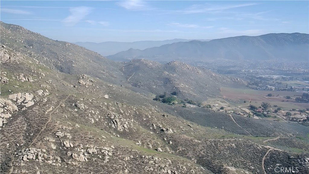 22600 Echo Lake Road Moreno Valley, CA 92557 - Photo 11 of 13 a view of a dry yard with mountains in the background