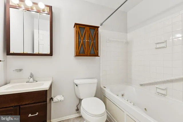 a bathroom with a toilet a sink and bathtub