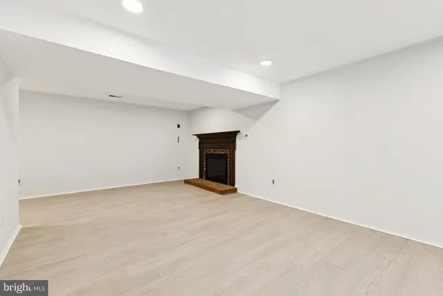 a view of an empty room with a fireplace
