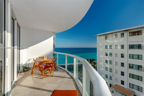 a view of a chairs and table in a balcony