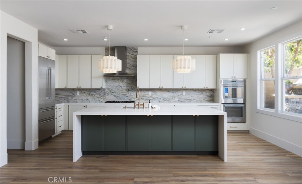 4158 Costero Risco San Clemente, CA 92673 - Photo 24 of 56 a kitchen with kitchen island granite countertop a sink and wooden cabinets