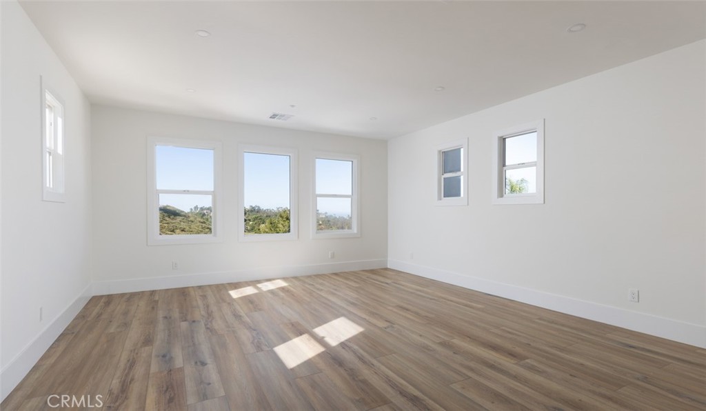 4158 Costero Risco San Clemente, CA 92673 - Photo 34 of 56 an empty room with wooden floor and windows