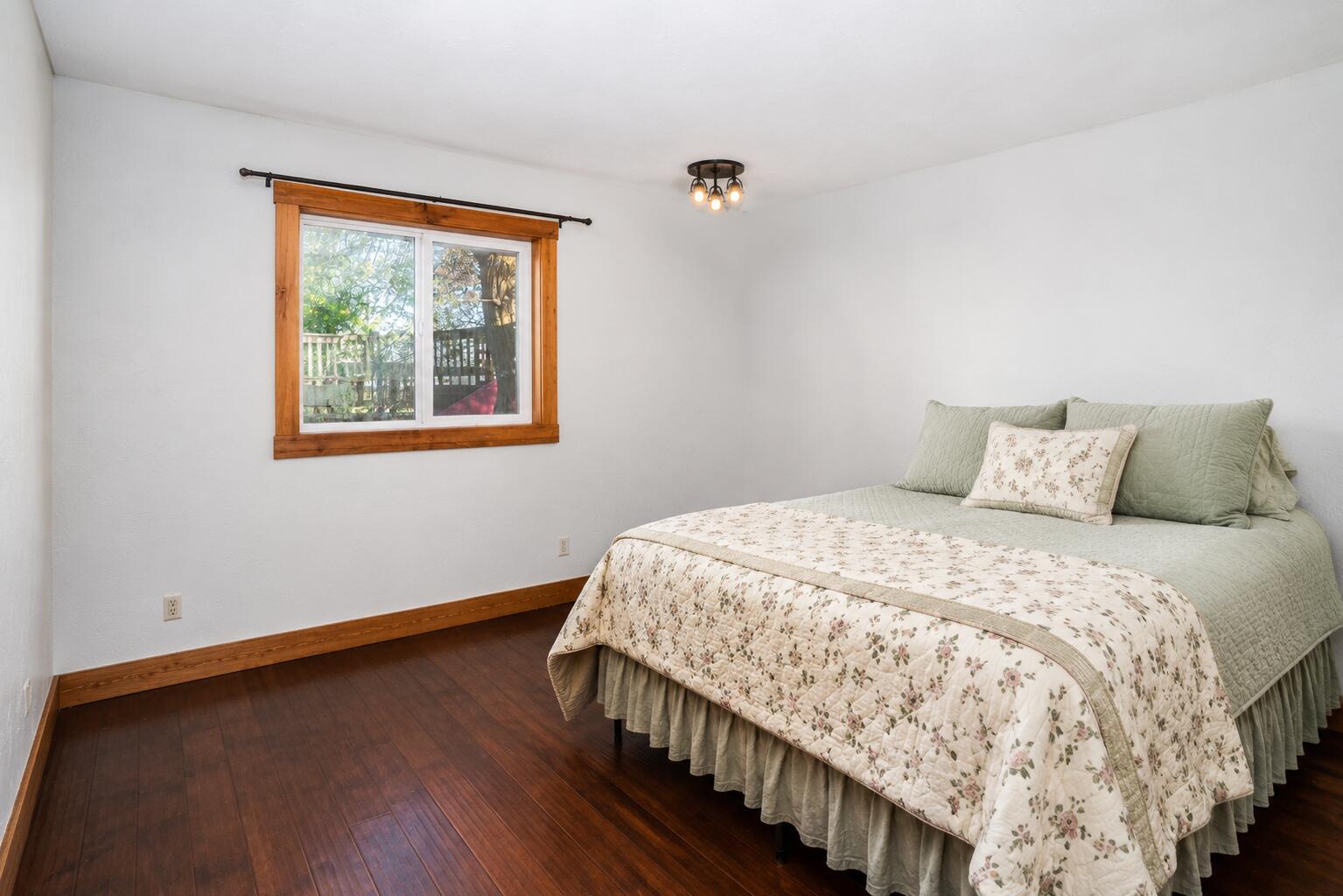 26695 Horsell Road Bend, OR 97701 - Photo 22 of 33 a bedroom with a bed and wooden floor