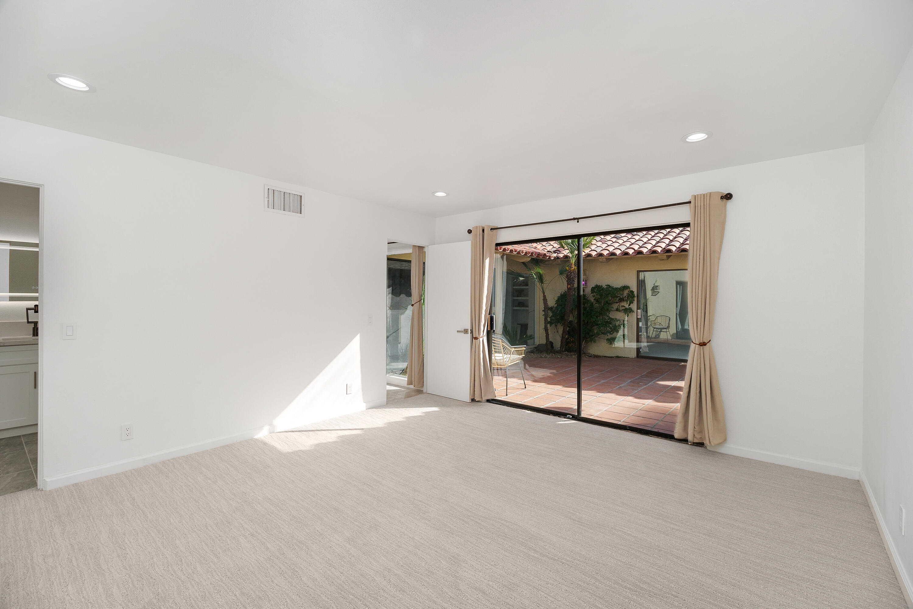 49835 Adelito Circle La Quinta, CA 92253 - Photo 22 of 36 a view of an empty room with a sliding door