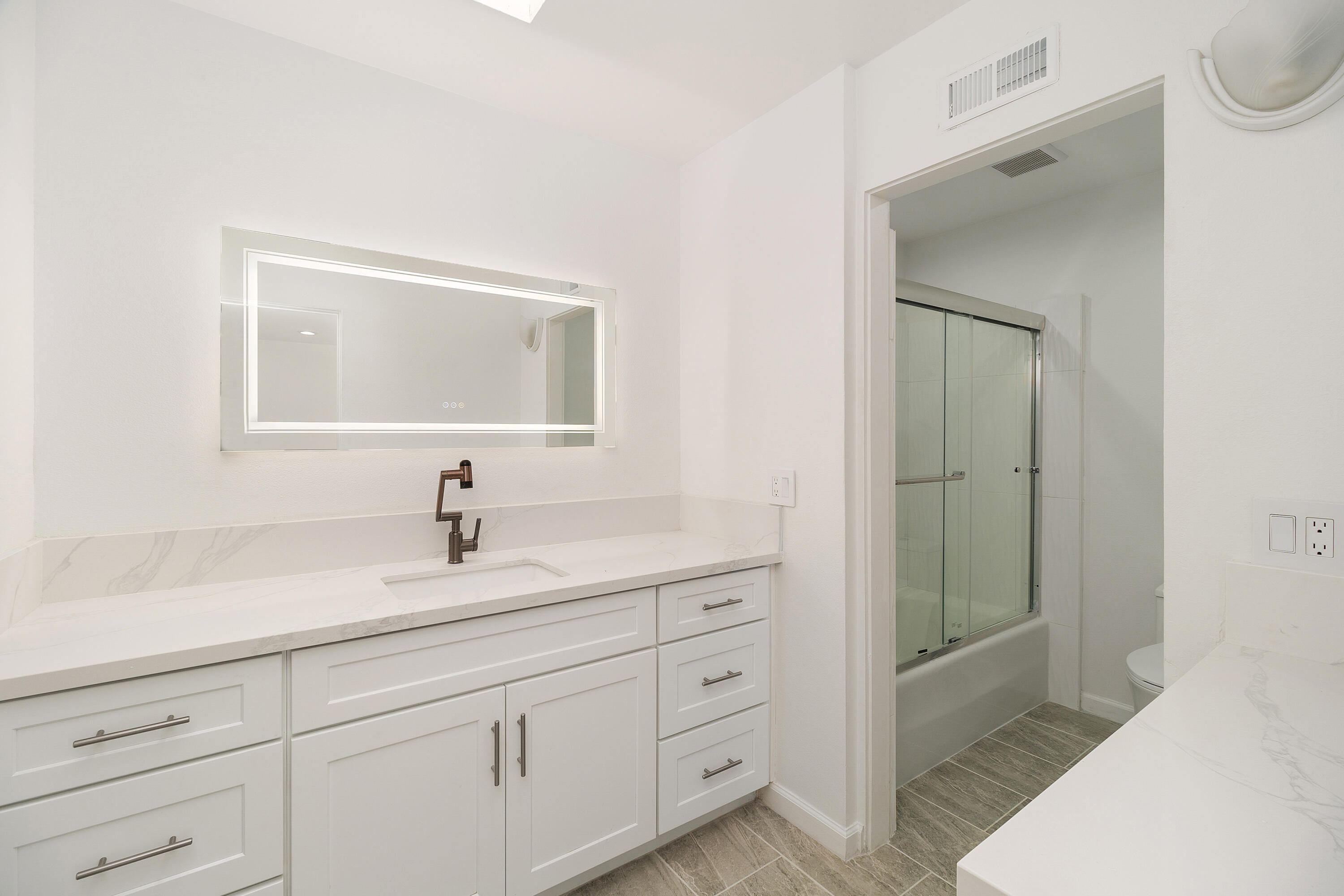 49835 Adelito Circle La Quinta, CA 92253 - Photo 23 of 36 a bathroom with a double vanity sink and mirror