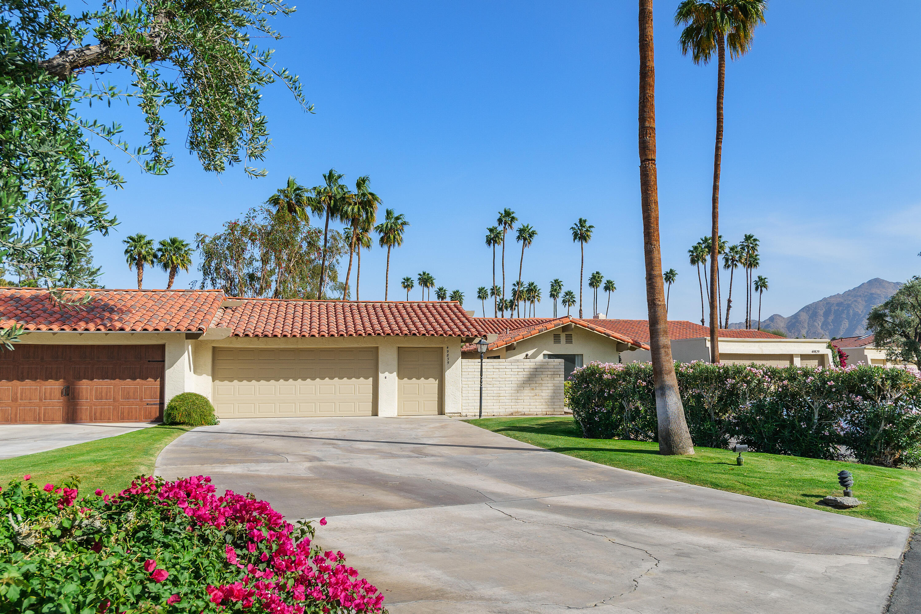 49835 Adelito Circle La Quinta, CA 92253 - Photo 25 of 36 a front view of a house with a yard and garage