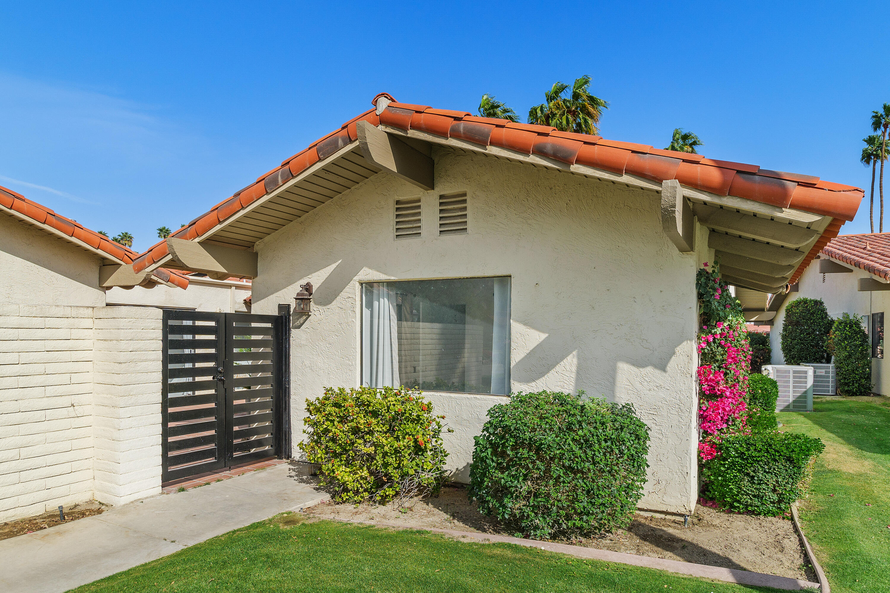 49835 Adelito Circle La Quinta, CA 92253 - Photo 26 of 36 a front view of a house with garden