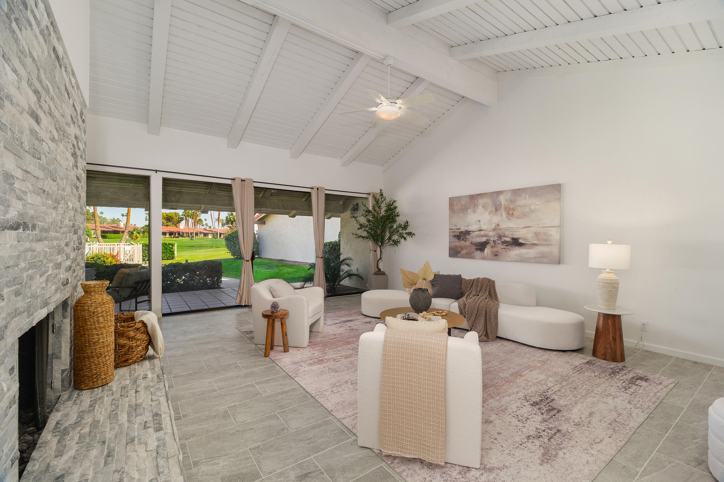 49835 Adelito Circle La Quinta, CA 92253 - Photo 4 of 36 a living room with fireplace furniture and a garden
