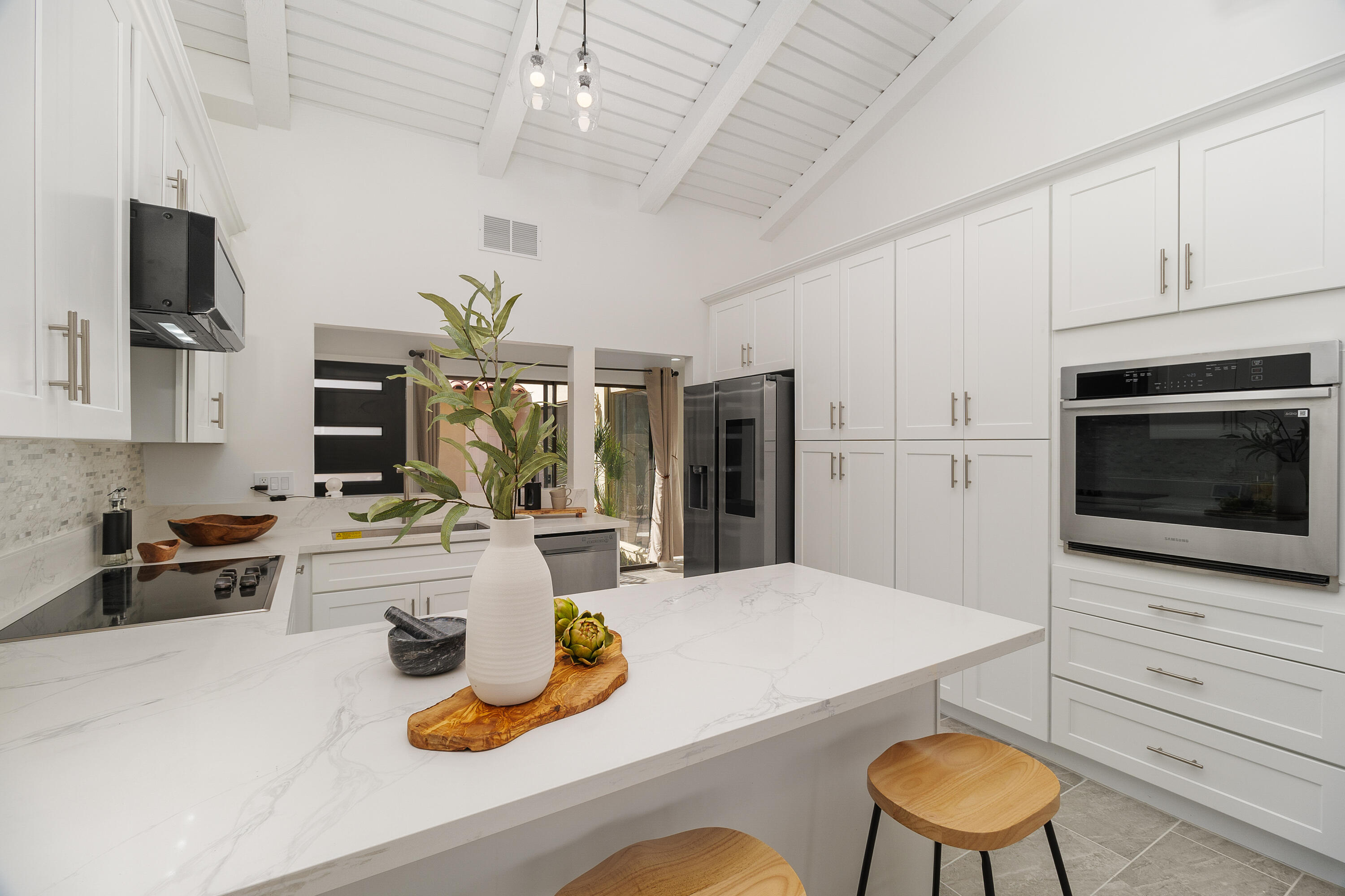 49835 Adelito Circle La Quinta, CA 92253 - Photo 7 of 36 a kitchen with sink refrigerator dining table and chairs