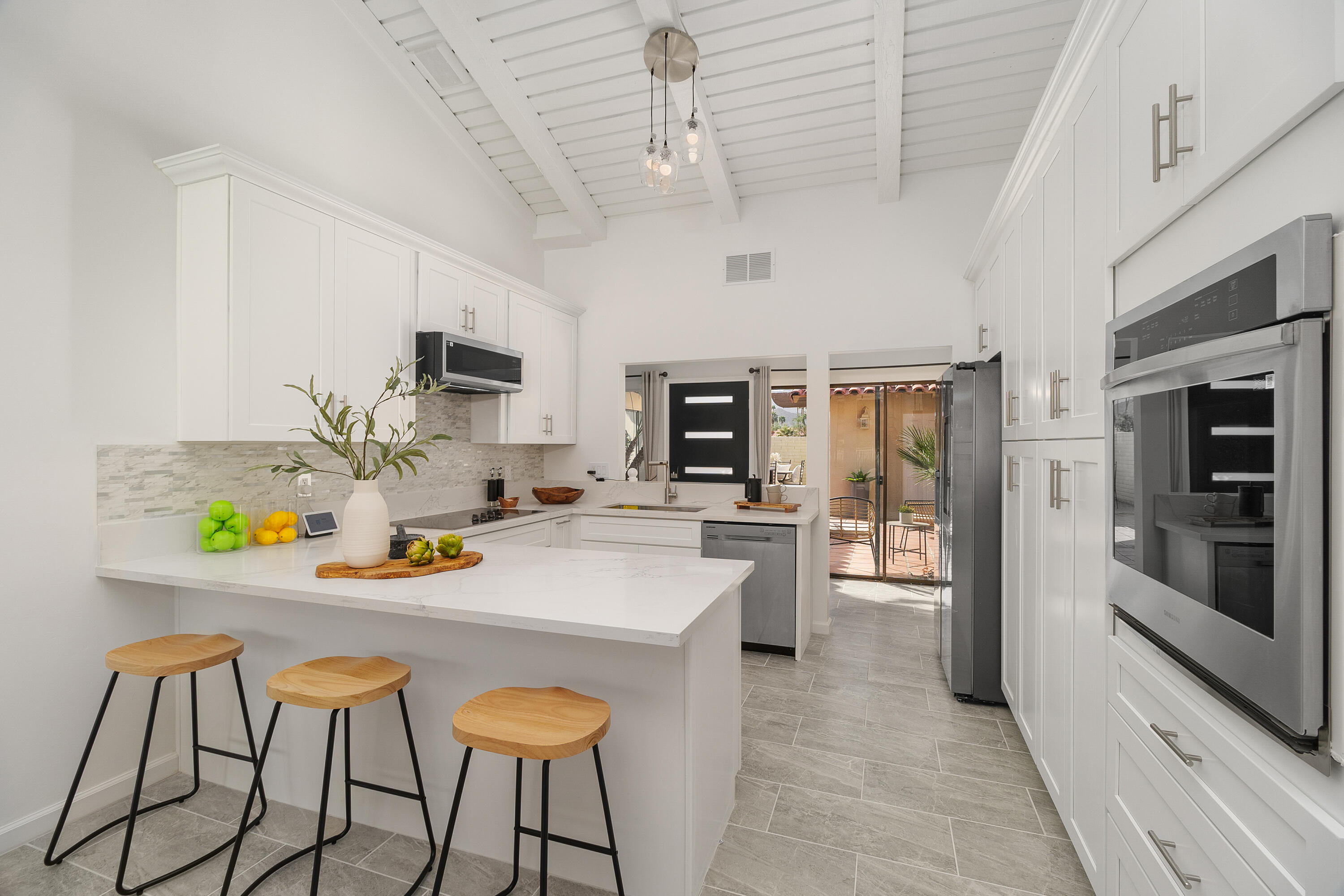 49835 Adelito Circle La Quinta, CA 92253 - Photo 8 of 36 a kitchen with stainless steel appliances granite countertop a sink refrigerator and cabinets