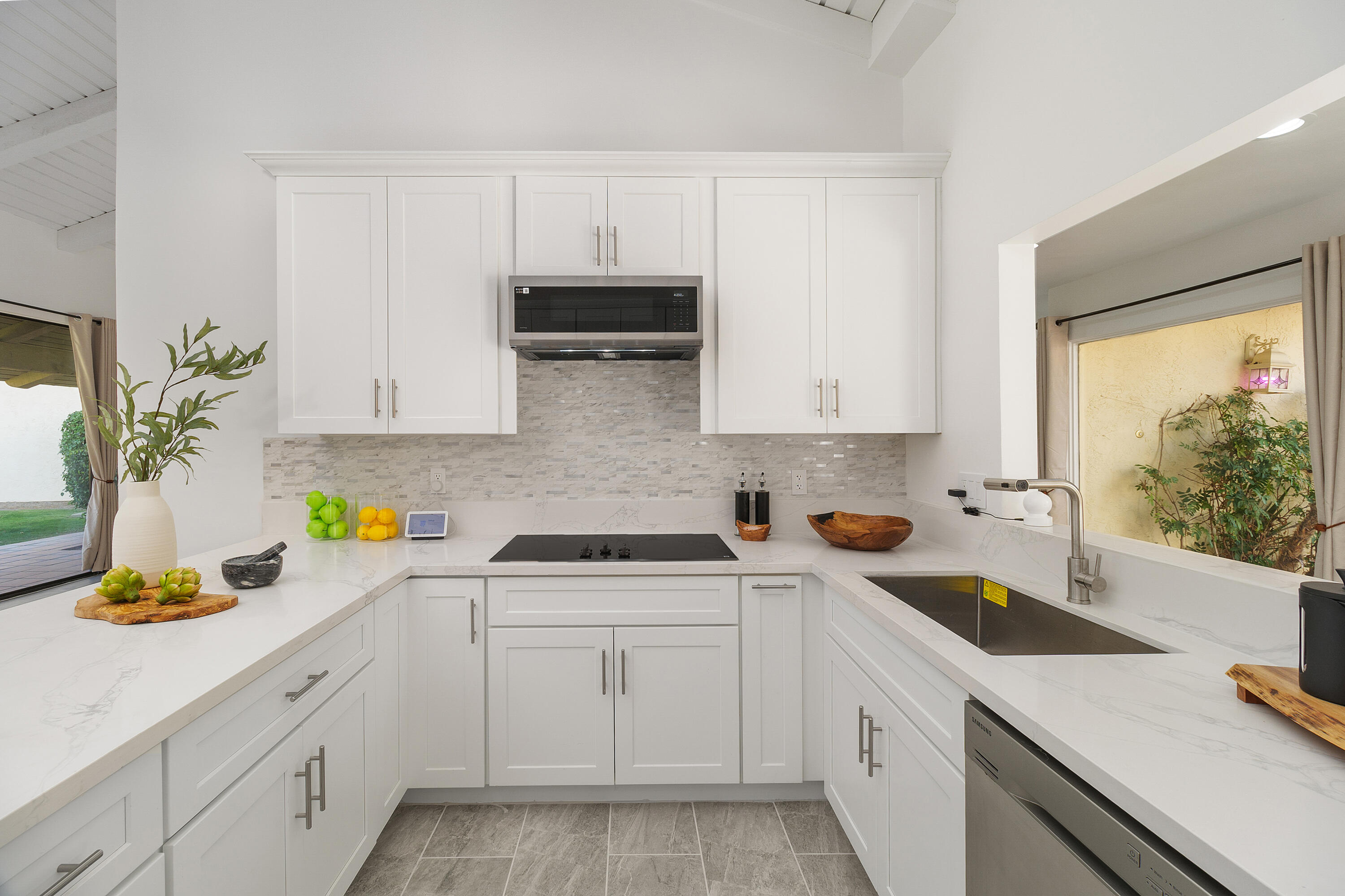 49835 Adelito Circle La Quinta, CA 92253 - Photo 9 of 36 a kitchen with white cabinets and appliances