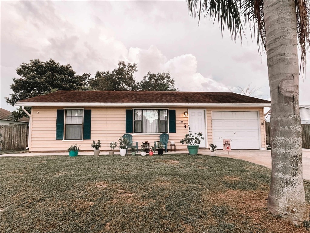 655 Chesser Avenue Sebastian, FL 32958 - Photo 1 of 17 a front view of house with yard seating and green space