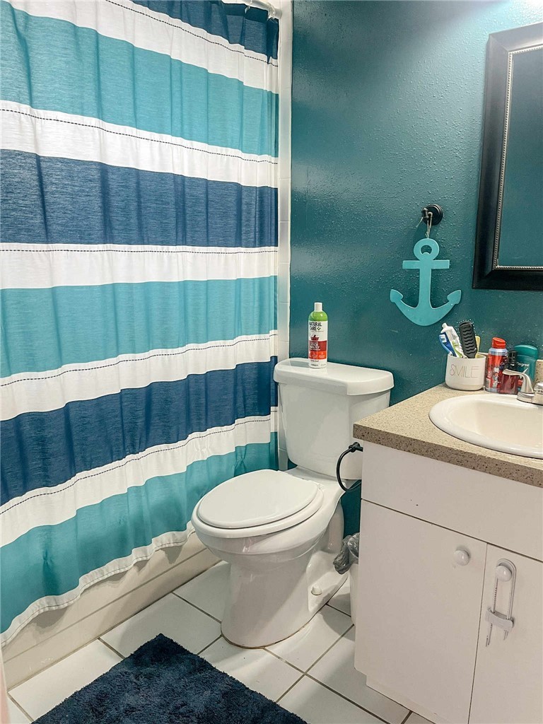 655 Chesser Avenue Sebastian, FL 32958 - Photo 13 of 17 a bathroom with a sink a toilet and a mirror
