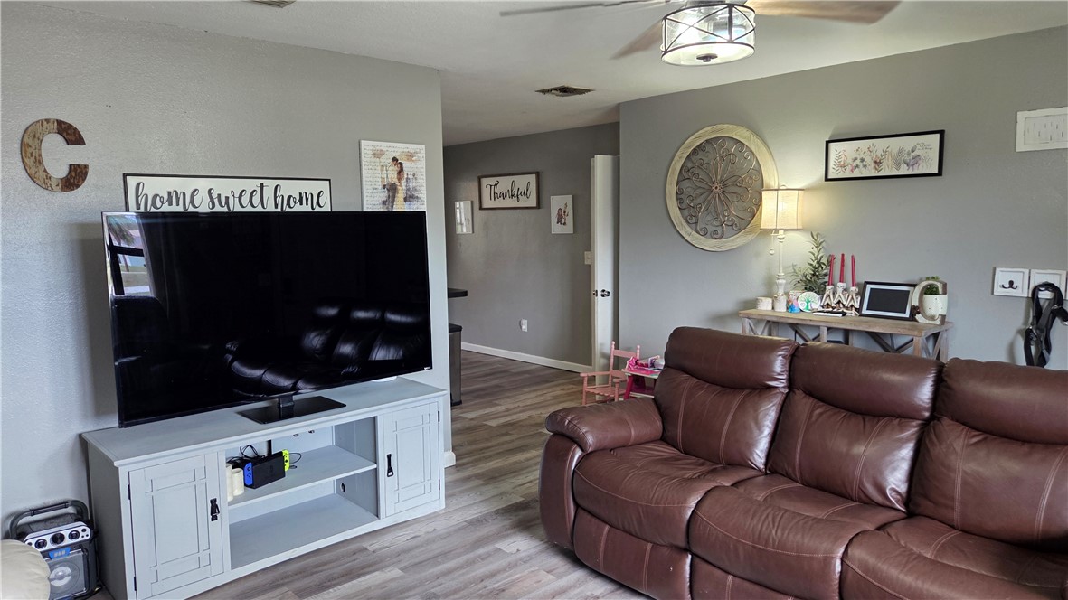 655 Chesser Avenue Sebastian, FL 32958 - Photo 3 of 17 a living room with furniture a mirror and a flat screen tv
