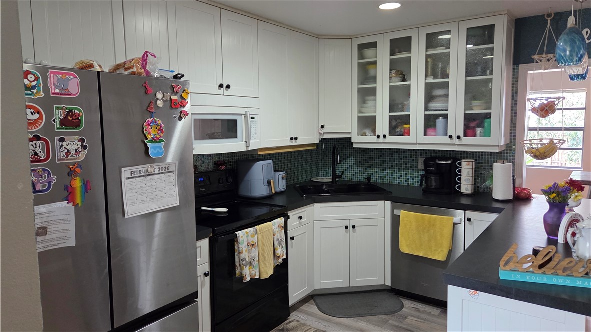 655 Chesser Avenue Sebastian, FL 32958 - Photo 4 of 17 a kitchen with stainless steel appliances granite countertop a refrigerator and a stove