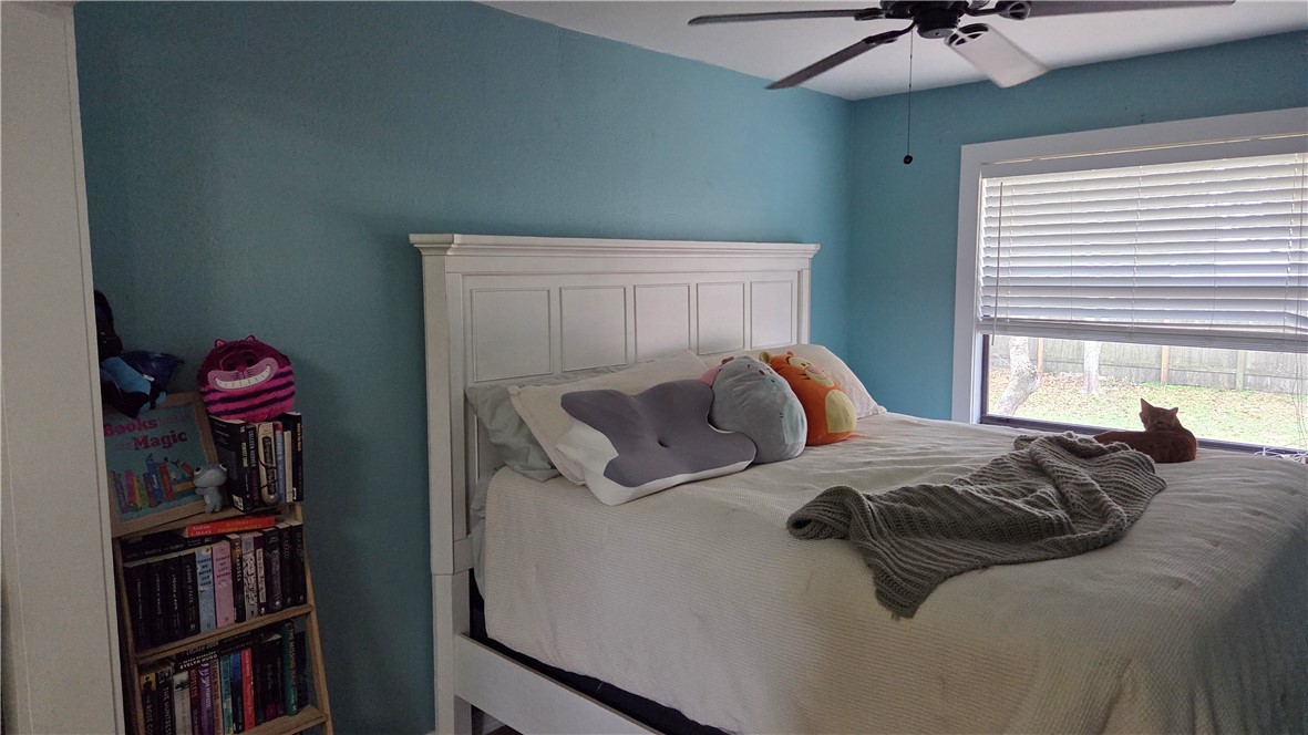 655 Chesser Avenue Sebastian, FL 32958 - Photo 7 of 17 a bed sitting in a bedroom next to a book shelf