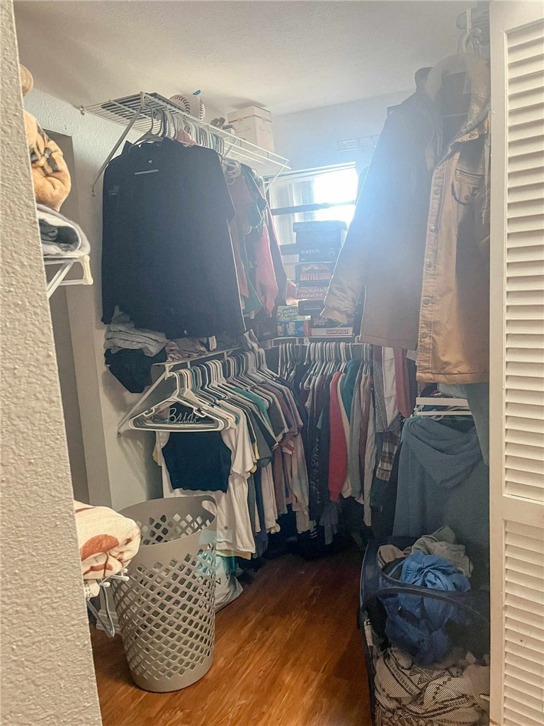 655 Chesser Avenue Sebastian, FL 32958 - Photo 9 of 17 a view of walk in closet with clothes and shoes